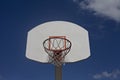Cloudy blue sky frames retro basketball goal.
