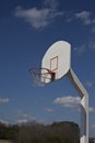 Cloudy blue sky frames retro basketball goal.