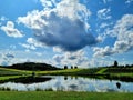 Cloudy blue sky green fields agricultural landscape Royalty Free Stock Photo