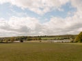 Cloudy blue sky over a country meadow grassland