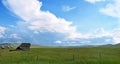 Cloudy blue sky over a green grass field Royalty Free Stock Photo