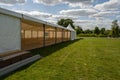 Cloudy blue sky over Marquee for party and events in a green field on a sunny day