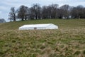 Cloudy blue sky over Marquee for party and events in a green field on a sunny day