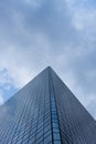 cloudy blue sky reflection skyscraper glass exterior trees framing