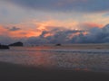 Cloudy and colorful sunset in front of the sea