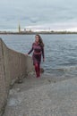 Cloudy day a beautiful girl on the waterfront Royalty Free Stock Photo