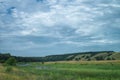 A cloudy day in a green summer hilly valley Royalty Free Stock Photo