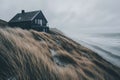 A cloudy day in Hvide Sande, Denmark, provides the setting for a scenic view of a house on Bjerregard beach Royalty Free Stock Photo