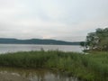 Cloudy day at the lake. water reflecting clouds Royalty Free Stock Photo