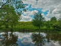 Cloudy day at the lake. water reflecting clouds Royalty Free Stock Photo