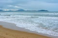 Cloudy day, sand deserted beach of the coast of Haitang Bay in South China Sea. Sanya, island Hainan, China. Nature Landscape Royalty Free Stock Photo