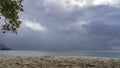 Cloudy day on a tropical beach. Clouds over a turquoise calm ocean. Royalty Free Stock Photo