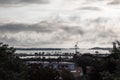 Cloudy daybreak with water reflections and windmill, Dorchester Bay Basin, Boston