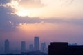 cloudy dusk dawn shot with the sun hidden and fog obscured sky scrapers multi story buildings of cityscape of gurgaon