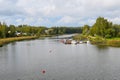 A cloudy early autumn day with boats, dock, homes and a park along the Porvoonjoki River in Porvoo, Finland