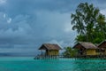 Cloudy Evening and Huts on the Water Royalty Free Stock Photo