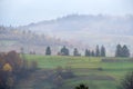 Cloudy and foggy autumn mountains scene. Peaceful picturesque traveling, seasonal, nature and countryside beauty concept scene. Royalty Free Stock Photo