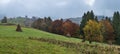 Cloudy and foggy autumn mountains scene. Peaceful picturesque traveling, seasonal, nature and countryside beauty concept scene. Royalty Free Stock Photo