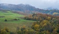 Cloudy and foggy day autumn mountains scene. Peaceful picturesque traveling, seasonal, nature and countryside beauty concept scene Royalty Free Stock Photo