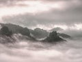 Cloudy hilly landscape. View over heavy cloud into rocky gulch