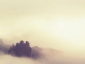 Cloudy hilly landscape. View over heavy cloud into rocky gulch