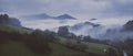 Cloudy landscape with dense and low fog between hills