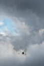 Cloudy landscape with edge of rocky mountains between the stormy sky