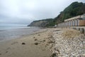Cloudy Morning View of Shanklin Beach, Beach Huts, and Coastal Cliff Royalty Free Stock Photo