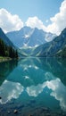 Cloudy mountain peaks mirrored in the surface of a peaceful lake calmness mirror reflective Royalty Free Stock Photo