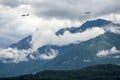 Cloudy mountains and planes passing by Royalty Free Stock Photo