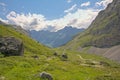 Cloudy mountains and valle with little river y in the French Alps