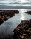 Cloudy ocean seen through rocks