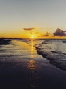 Cloudy orange sunset over sea water, sunset over sea waves. Royalty Free Stock Photo