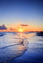 Cloudy orange sunset over sea water, sunset over sea waves. Royalty Free Stock Photo