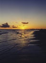 Cloudy orange sunset over sea water, sunset over sea waves. Royalty Free Stock Photo