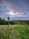 Cloudy overcast summer sunrise over the South Downs Way footpath from Beacon Hill and Harting Down in the South Downs National