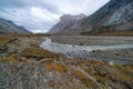 A cloudy, rainy day in remote arctic valley of Akshayuk Pass, Baffin Island, Canada. Hiking north in remote wilderness