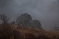 Cloudy rainy mountains. Rock`s tom in fog