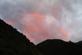 Cloudy Red sky with rainbow and hills angular view mountain