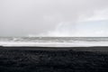 Cloudy skies, Atlantic Ocean waves and black sand on Vik beach, Iceland. Royalty Free Stock Photo