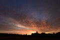 Cloudy skies in the light of dawn over the forest Royalty Free Stock Photo