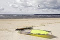 Cloudy skies, seaside and windsurf sailing board