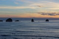 Cloudy skies and sunset over Oregon Coast Pacific ocean rocky outcrops