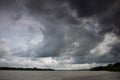 Cloudy skies. Thick black clouds on the chest of the river. The cloudy sky merged with the river Royalty Free Stock Photo