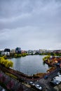 Cloudy sky in autumn, over a city park lake in Cluj-Napoca, Romania with a skyline in the background Royalty Free Stock Photo