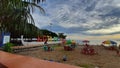 Cloudy sky beach with plastic chair and umbrella Royalty Free Stock Photo