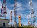 Cloudy sky behind telecommunication wireless towers with antennas