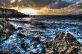 Cloudy sky over Alghero shoreline at sunset Royalty Free Stock Photo