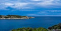 Cloudy sky over a big rock and sea Royalty Free Stock Photo