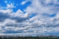 Cloudy sky over the city. A lot of clouds are going to storm front. Blue sky and clouds on a summer day